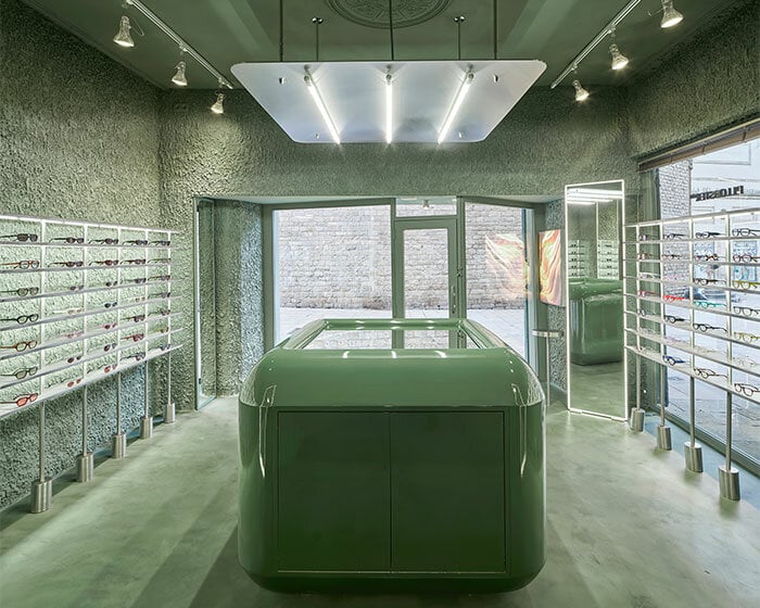 high-tech elements and 'texturized minimalism' shape all-green optical boutique in barcelona