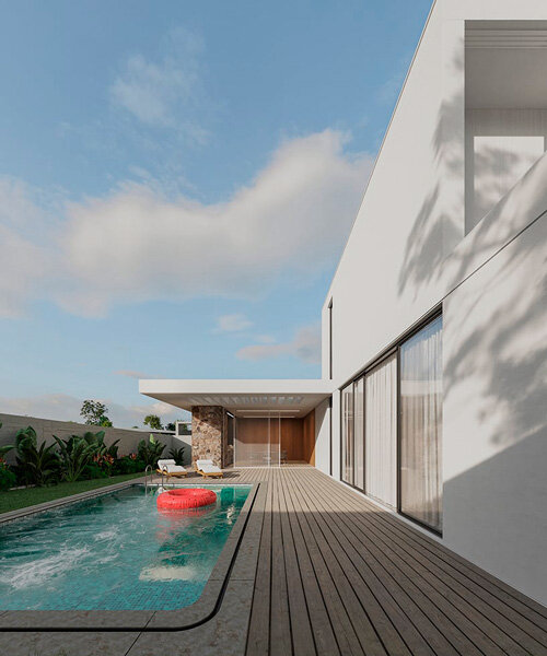 white cantilever glazed volume stands on stone plinth in cyprus