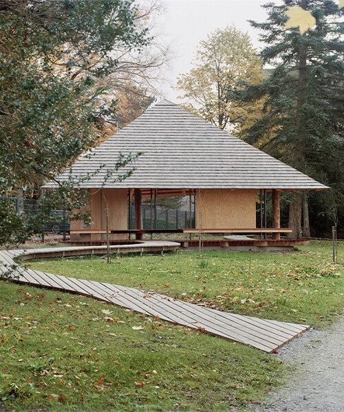 charly jolliet's umbrella-shaped canopy in switzerland spotlights traditional wood cladding