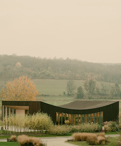 wellness pavilion with curved roof echoes contours of natural landscape in hungary